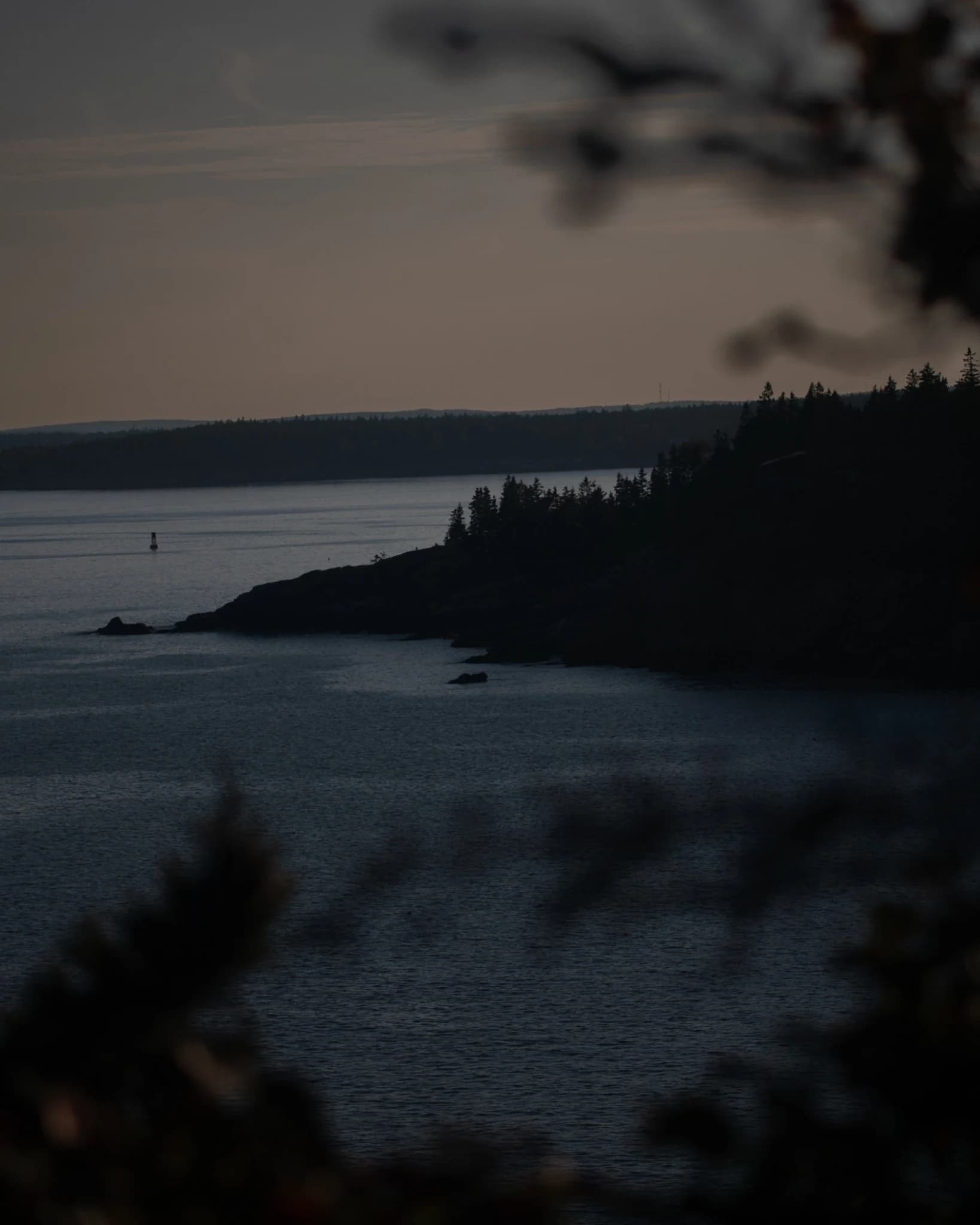 Dark Maine coastline at dusk